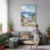 04 - New Zealand Queenstown Watercolor Canvas Print with Natural Floater Frame - Woman Knitting on grey couch - Vertical.jpg