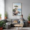 04 - Pebble Beach Cypress Watercolor Canvas Print with Natural Floater Frame - Woman Knitting on grey couch - Vertical.jpg