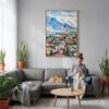 04 - Reykjavik Watercolor Canvas Print with Natural Floater Frame - Woman Knitting on grey couch - Vertical.jpg