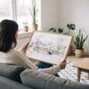 05 - A Woman Holding A Framed New York Central Park in Winter Watercolor - Horizontal Art Print.jpg