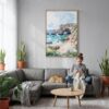 05 - Algarve Portugal Watercolor Canvas Print with Natural Floater Frame - Woman Knitting on grey couch - Vertical.jpg