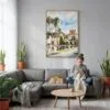 05 - Balboa Park Watercolor Canvas Print with Natural Floater Frame - Woman Knitting on grey couch - Vertical.jpg