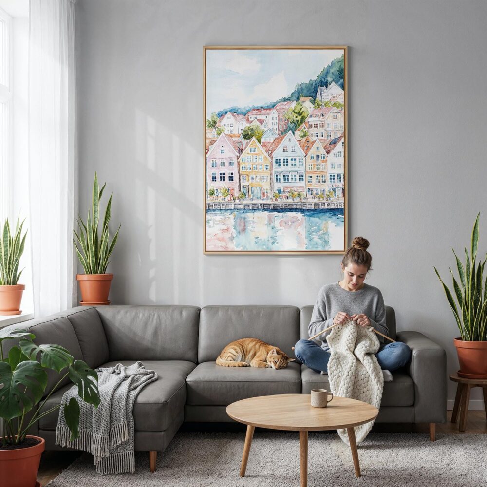 05 - Bergen Norway Houses Watercolor Canvas Print with Natural Floater Frame - Woman Knitting on grey couch - Vertical.jpg 05 - Bergen Norway Houses Watercolor Canvas Print with Natural Floater Frame - Woman Knitting on grey couch - Vertical.jpg