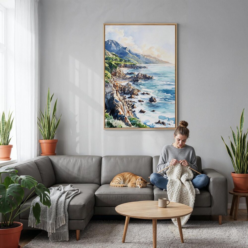 05 - Big Sur California Watercolor Canvas Print with Natural Floater Frame - Woman Knitting on grey couch - Vertical.jpg 05 - Big Sur California Watercolor Canvas Print with Natural Floater Frame - Woman Knitting on grey couch - Vertical.jpg