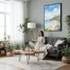 05 - Framed Laguna Beach Watercolor Canvas Print - Woman reading in Boho Living Room - Vertical.jpg