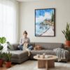 05 - Framed Lake Garda Italy Watercolor Canvas Print - Woman Knitting on grey couch - Vertical.jpg