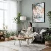 05 - Framed Miami Florida Sunset Watercolor Canvas Print - Woman reading in Boho Living Room - Vertical.jpg