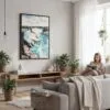 05 - Framed Niagara Falls Watercolor Canvas Print - Woman reading in modern Living Room - Vertical.jpg