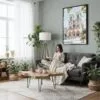 05 - Framed Notre Dame Watercolor Canvas Print - Woman reading in Boho Living Room - Vertical.jpg