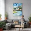 05 - Salzburg Austria Watercolor Canvas Print with Natural Floater Frame - Woman Knitting on grey couch - Vertical.jpg