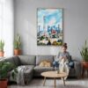 06 - Beijing Skyline Watercolor Canvas Print with Natural Floater Frame - Woman Knitting on grey couch - Vertical.jpg