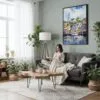 06 - Framed Cape Cod Watercolor Canvas Print - Woman reading in Boho Living Room - Vertical.jpg