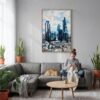 06 - London Business Skyline Watercolor Canvas Print with Natural Floater Frame - Woman Knitting on grey couch - Vertical.jpg