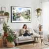 02 - Framed Cotswolds England Watercolor - Horizontal Canvas Print - Boho Living Room with Woman reading.jpg