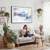 04 - Framed Skiing in Grindelwald Watercolor - Horizontal Canvas Print - Boho Living Room with Woman reading.jpg