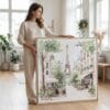 02 - Woman standing in living room with Large Paris Cafe and Eiffel Tower Watercolor - Square Canvas Print with Natural floater Frame.jpg