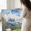 02 - Woman standing next to Large Colorado Rocky Mountains Watercolor - Square Canvas Print with Natural floater Frame.jpg