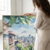 03 - Woman standing next to Large Seattle Watercolor - Square Canvas Print with Natural floater Frame.jpg