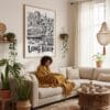 02 - Framed Long Beach City Art - Pencil Style Art Print - In Bohi Living Room with Woman reading - Vertical.jpg
