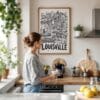 02 - Framed Louisville City Art - Pencil Style Art Print hanging in Kitchen with woman making coffee - Vertical.jpg
