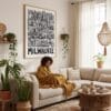 02 - Framed Milwaukee City Art - Pencil Style Art Print - In Bohi Living Room with Woman reading - Vertical.jpg