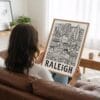 02 - Woman Holding Framed Raleigh City Art - Pencil Style Art Print - Vertical.jpg