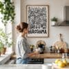 03 - Framed Hiroshima City Art - Pencil Style Art Print hanging in Kitchen with woman making coffee - Vertical.jpg