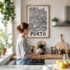 03 - Framed Porto City Art - Pencil Style Art Print hanging in Kitchen with woman making coffee - Vertical.jpg