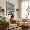03 - Framed Venice City Art - Pencil Style Art Print - In Bohi Living Room with Woman reading - Vertical.jpg