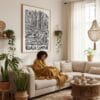 05 - Framed Kuala Lumpur City Art - Pencil Style Art Print - In Bohi Living Room with Woman reading - Vertical.jpg
