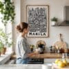 05 - Framed Manila City Art - Pencil Style Art Print hanging in Kitchen with woman making coffee - Vertical.jpg