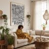 05 - Framed Rome City Art - Pencil Style Art Print - In Bohi Living Room with Woman reading - Vertical.jpg